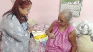Professional caregiver providing elder care service at home in Kolkata