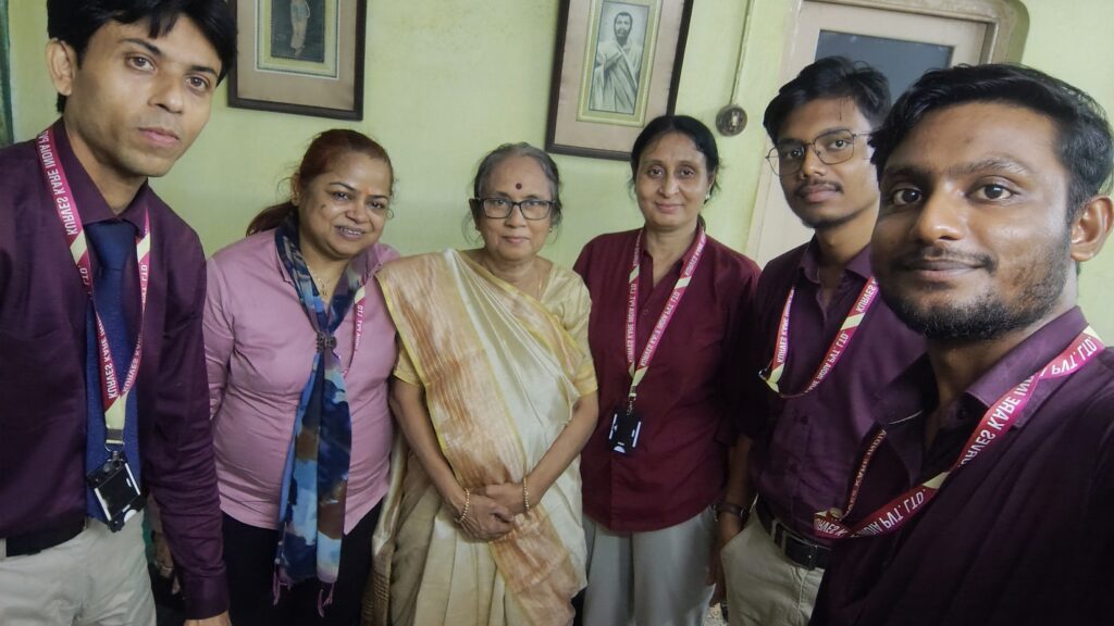 Caregiver assisting elderly person at home with digital health monitoring in Kolkata