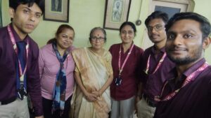 Caregiver assisting elderly person at home with digital health monitoring in Kolkata