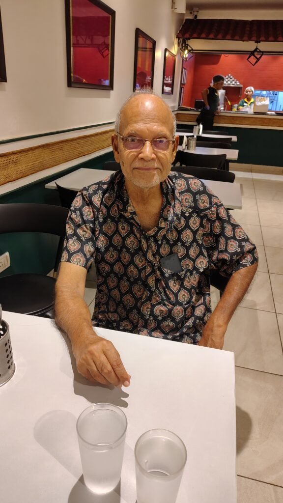 A professional pharmacist in Kolkata organizing a weekly pill dispenser for a senior citizen.