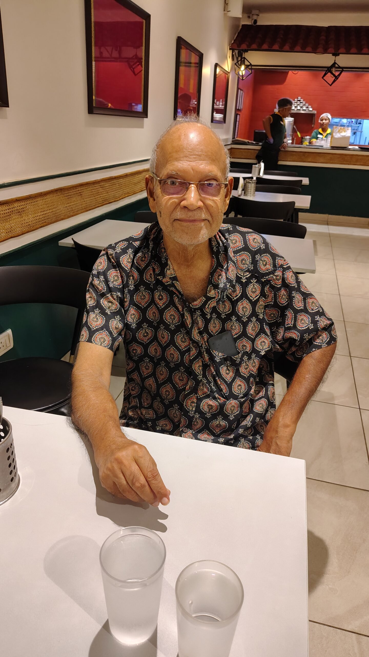 A professional pharmacist in Kolkata organizing a weekly pill dispenser for a senior citizen.